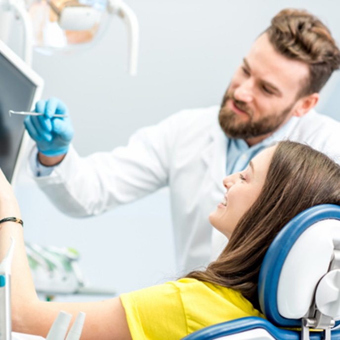 Dentist in St. Johns explaining X-ray to a patient