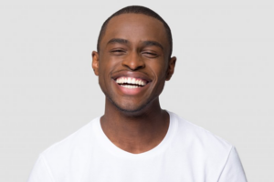 Man smiling brightly on white background